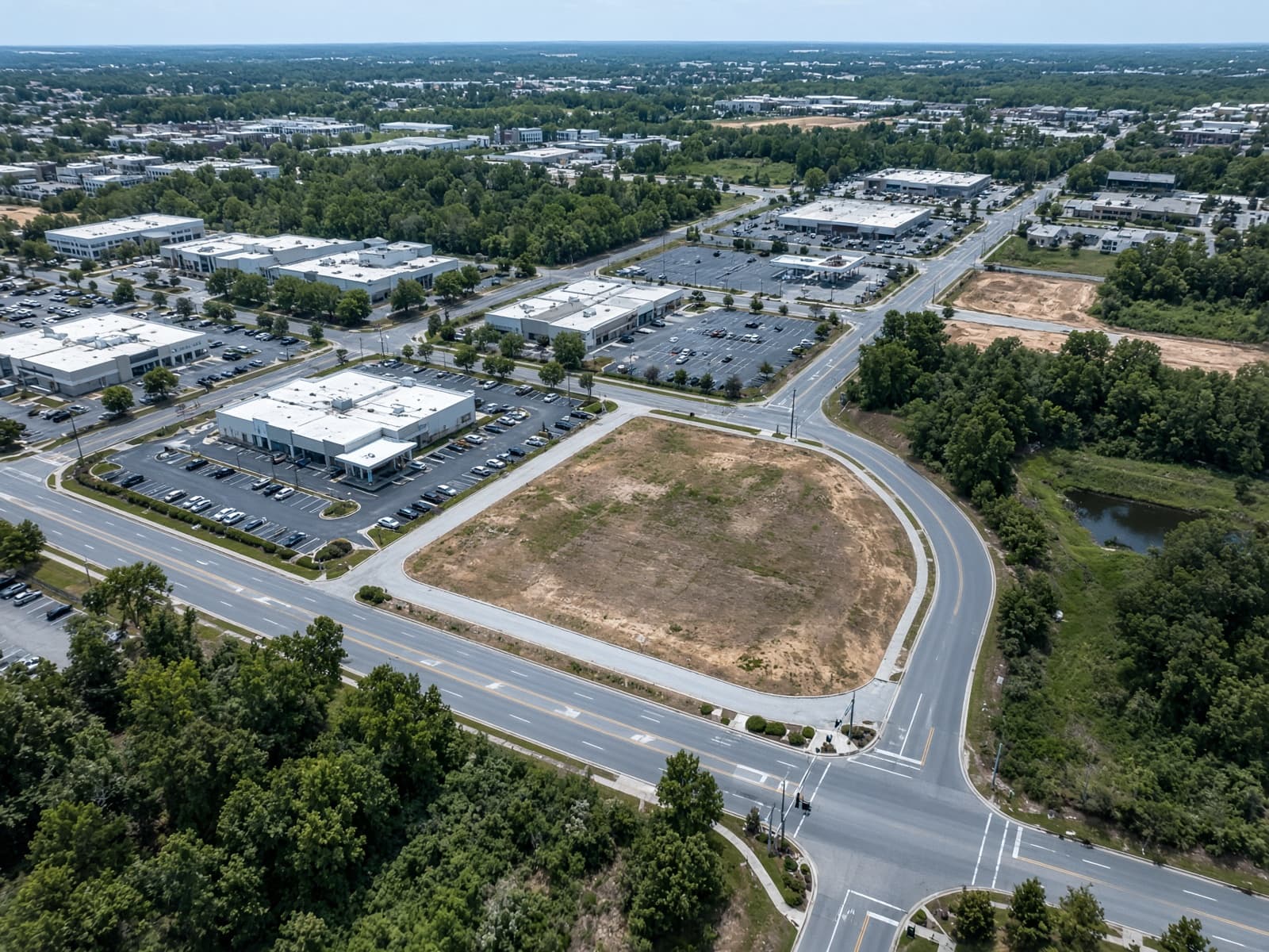 Aerial view of a commercial property, roads, and surrounding development, used to illustrate property intelligence.