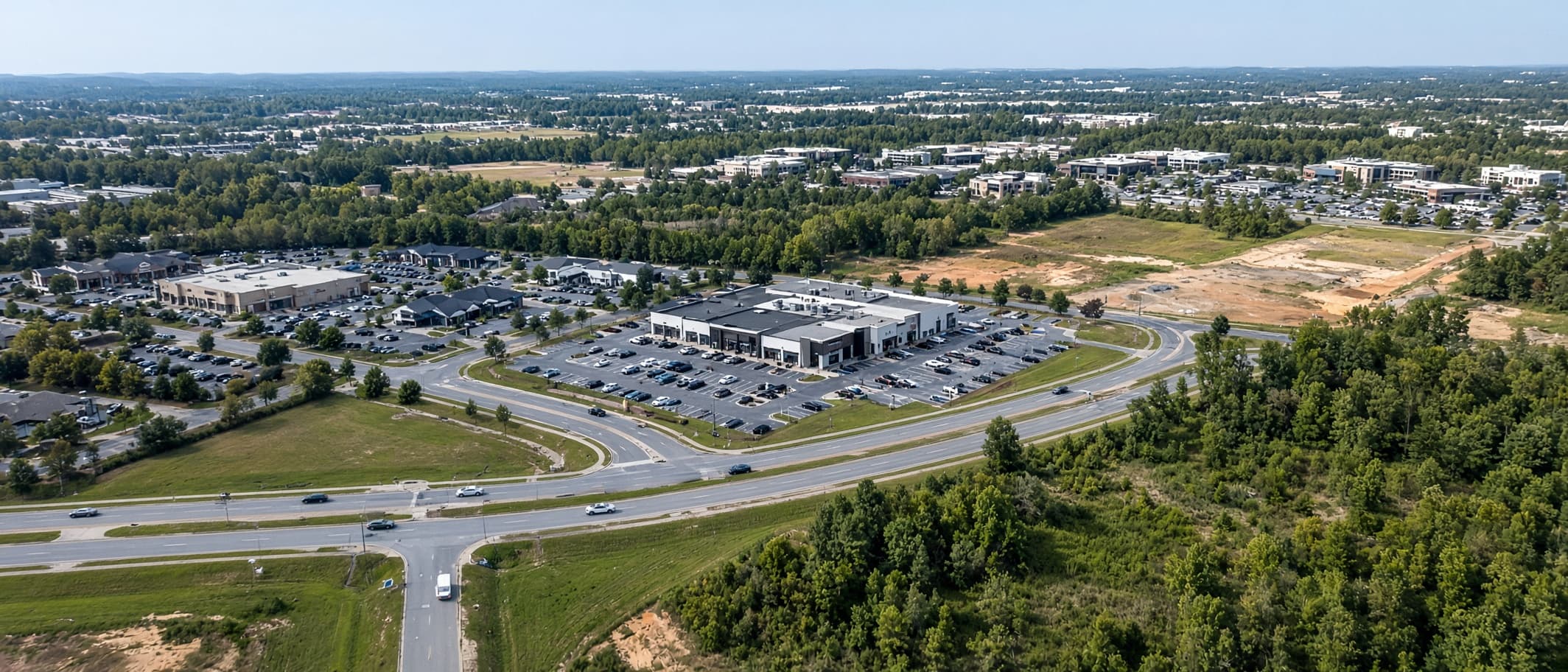 Aerial view of a commercial property, roads, and surrounding development, used to illustrate property intelligence.